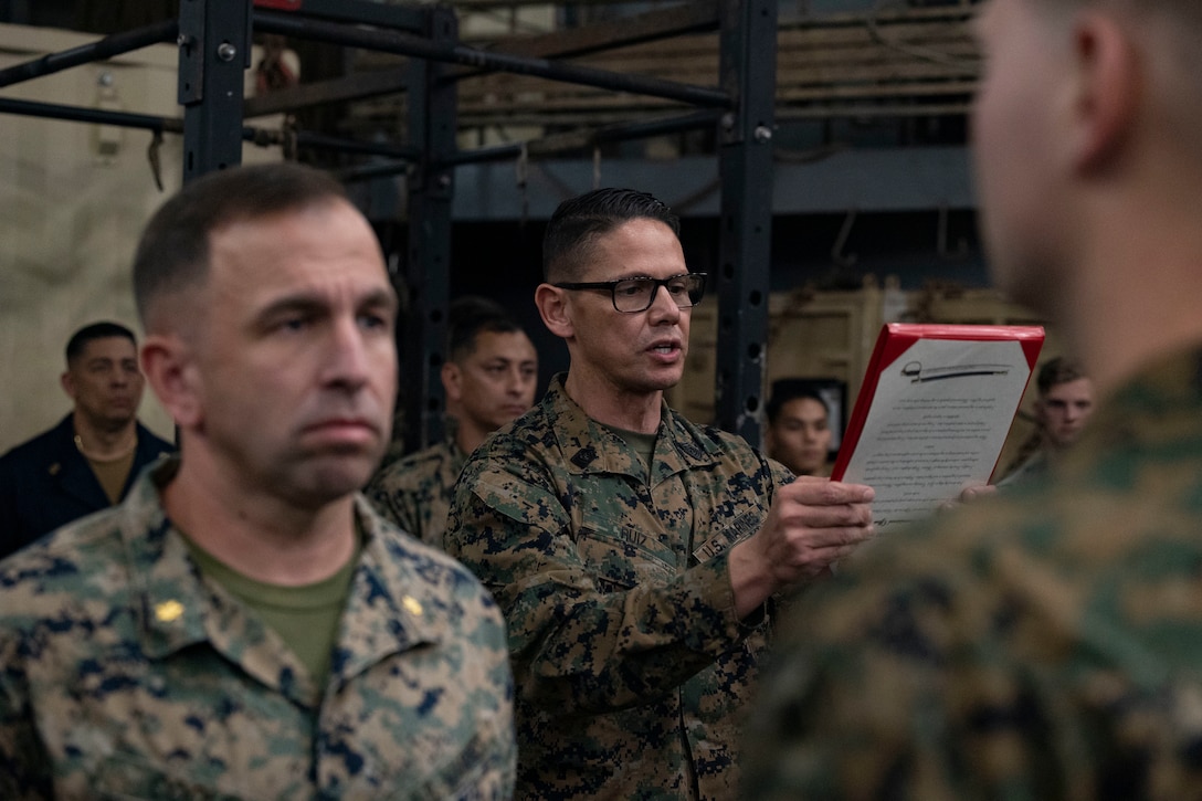 U.S. Marine Corps Sgt. Maj. Carlos A. Ruiz, Sergeant Major of the Marine Corps, reads a promotion warrant during an all-hands formation aboard the Harpers Ferry-class dock landing ship USS Carter Hall (LSD-50), Souda Bay, Greece, March 1, 2024. The 20th Sergeant Major of the Marine Corps visited the forward deployed 26th MEU(SOC) and met with leadership while also hosting discussions with Marines and Sailors. The Bataan Amphibious Ready Group, with the embarked 26th MEU(SOC) is on a scheduled deployment in the U.S. Naval Forces Europe area of operations, employed by U.S. Sixth Fleet to defend U.S., Allied and partner interests. (U.S. Marine Corps photo by Cpl. Michele Clarke)
