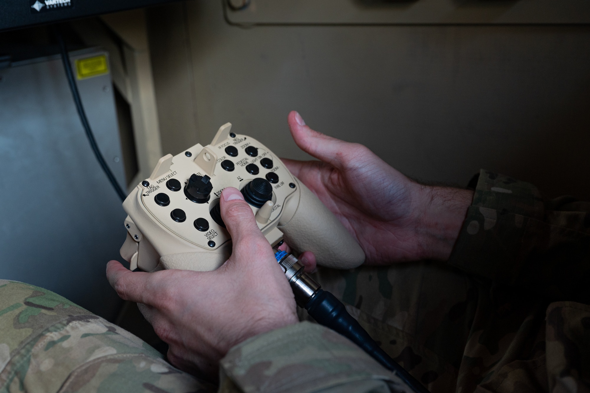 U.S. Air Force Senior Airman Thomas Giglio, a 36th Civil Engineer Squadron explosive ordnance disposal team member, prepares to shoot a smoke grenade using a control that signals a laser mounted on a Recovery of Air Bases Denied by Ordnance (RADBO) truck during a demonstration at Pacific Regional Training Center - Andersen, Guam, Jan. 30, 2024. The demonstration is the first time Andersen Air Force Base has exercised the RADBO truck and laser capabilities. The RADBO truck itself was designed to reduce hazard and protect service members as the laser disposes of ordnances on an airfield. (U.S. Air Force photo by Senior Airman Jasmine M. Barnes)