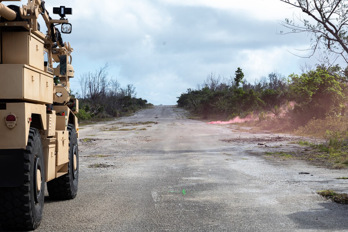 A smoke grenade burns during a demonstration at Pacific Regional Training Center - Andersen, Guam, Jan. 30, 2024. A laser mounted on top of a Recovery of Air Bases Denied by Ordnance truck was showcased to allies and sister service members. The laser disposes of explosives in a safe and efficient manner while the RADBO truck itself reduces hazard and protects service members. (U.S. Air Force photo by Senior Airman Jasmine M. Barnes)