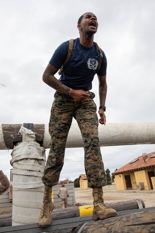 U.S Marine Corps Sgt. Immanuel Chrisp, a drill instructor with Kilo Company, 3rd Recruit Training Battalion, motivates recruits during an obstacle course training event at Marine Corps Recruit Depot San Diego, California, Feb. 29, 2024.  The o-course includes obstacles that recruits must overcome to enhance strength, agility, and confidence. (U.S. Marine Corps photo by Lance Cpl. Sarah M. Grawcock)