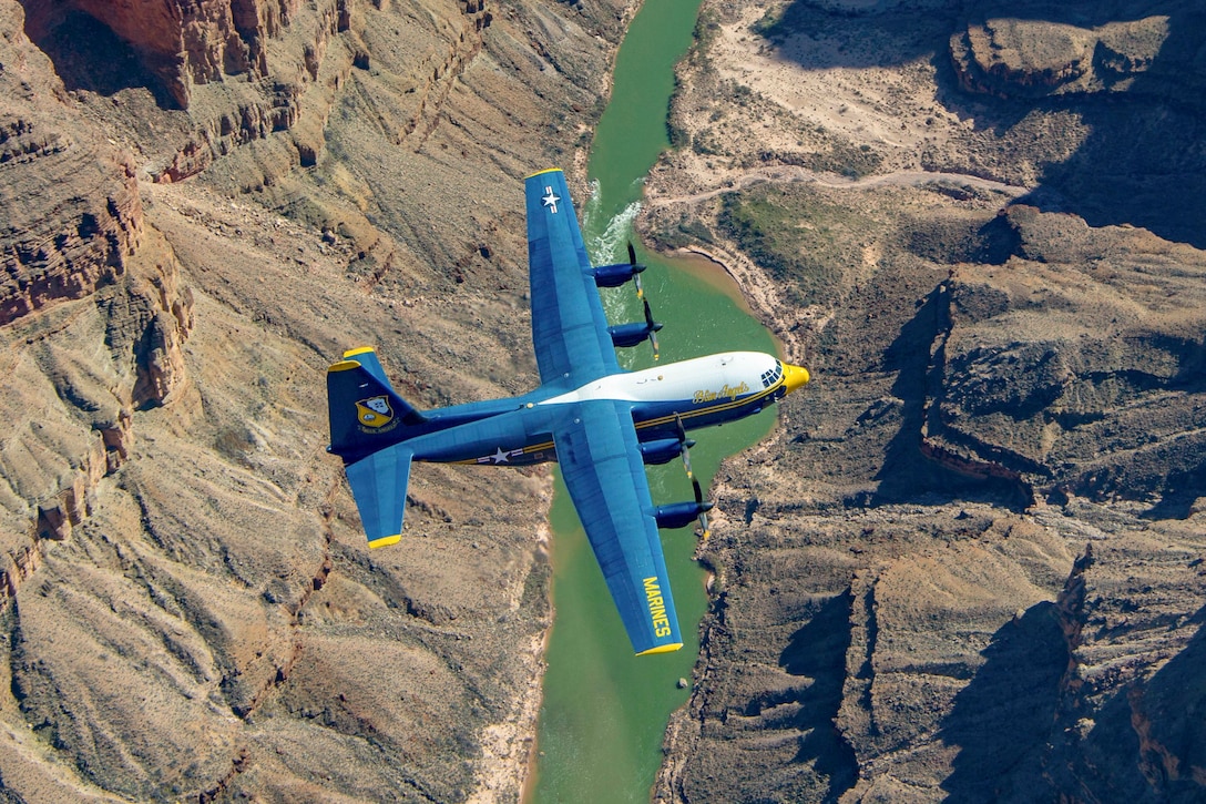 An aircraft flies over the Grand Canyon as seen from above.
