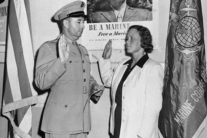 A person is sworn into the military in a black and white photo.