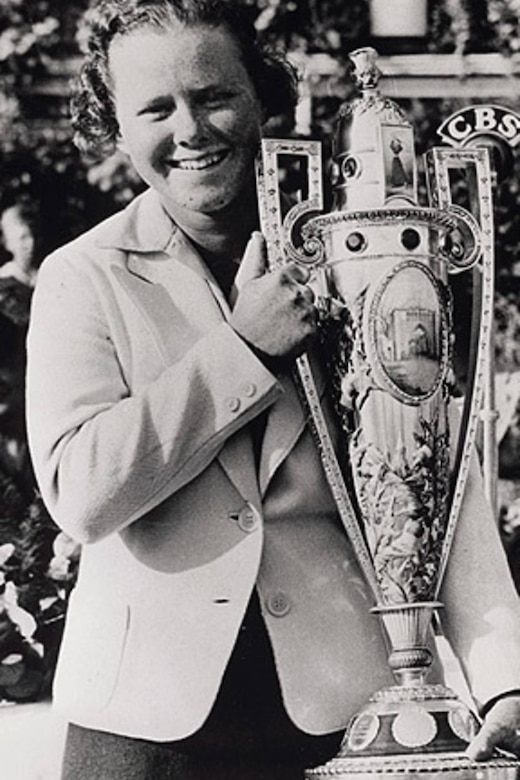 A person holds a trophy in a black and white photo.