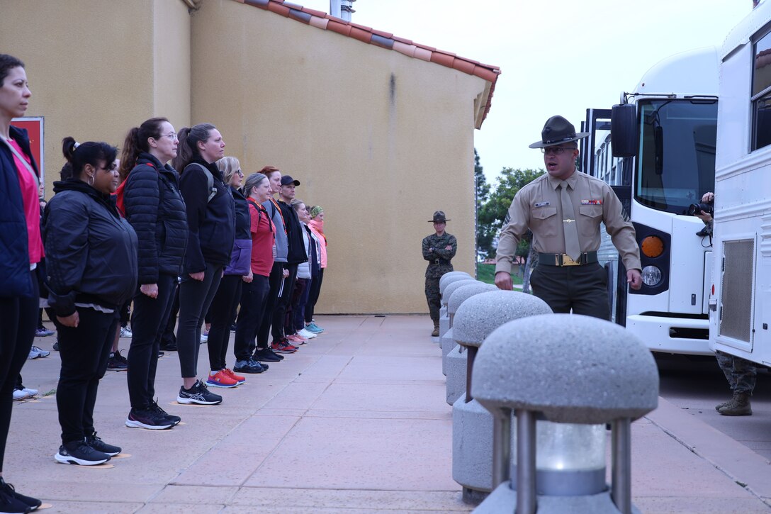 Educators with Recruiting Stations’ Indianapolis, Kansas City, Milwaukee, and Twin Cities experience the yellow footprints and are briefed on the uniform code of military justice as part of the 2024 Educator’s Workshop on Feb. 20, 2024 at Marine Corps Recruit Depot San Diego, California. Participants of the workshop visit MCRD San Diego to observe recruit training and gain a better understanding about the transformation from recruits to United States Marines.  (U.S. Marine Corps photo by Cpl. Collette Hagen)