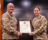 Col. Randy Edwards, Director of Plans, Training, and Operations for the Illinois Army National Guard, presents Maj. Christine Hurley with a certificate of retirement in recognition of her nearly 30 years of military service during a ceremony March 1 at the Illinois Military Academy, Camp Lincoln, Springfield.