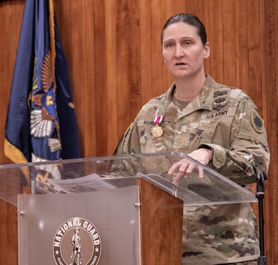 Illinois Army National Guard Maj. Christine Hurley, of Springfield, the collective training branch chief of the Illinois Army National Guard, thanks family, friends and fellow Soldiers for their support during her nearly 30 years of military service during a ceremony March 1 at Camp Lincoln, Springfield.