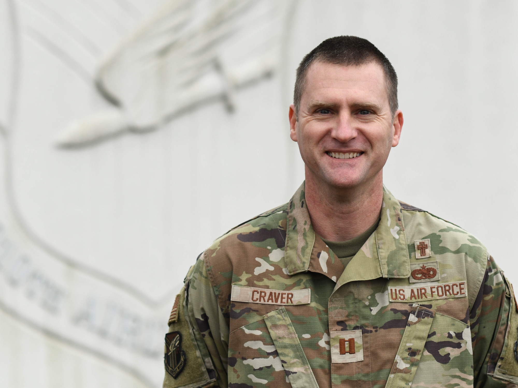Chaplain Douglas Craver, 910th Airlift Wing assistant chaplain poses for a photo at the entrance to Youngstown Air Reserve Station, Ohio, on March 2, 2024.