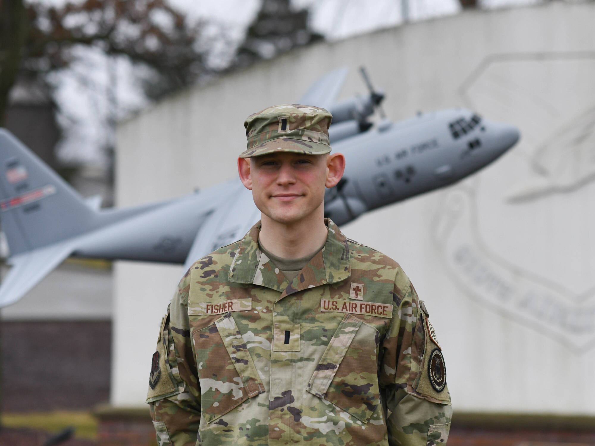 Chaplain Forest Fisher, 910th Airlift Wing assistant Chaplain poses for a photo at the entrance to Youngstown Air Reserve Station, Ohio, on March 2, 2024.