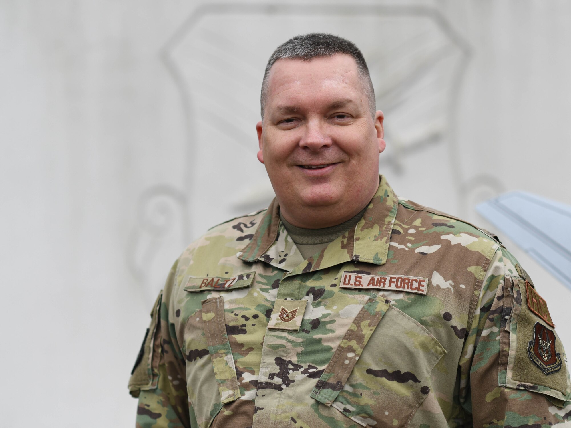 Tech. Sgt. John Baltz, noncommissioned officer in charge of Chapel operations, poses for a photo at the entrance to Youngstown Air Reserve Station, Ohio, on March 2, 2024.