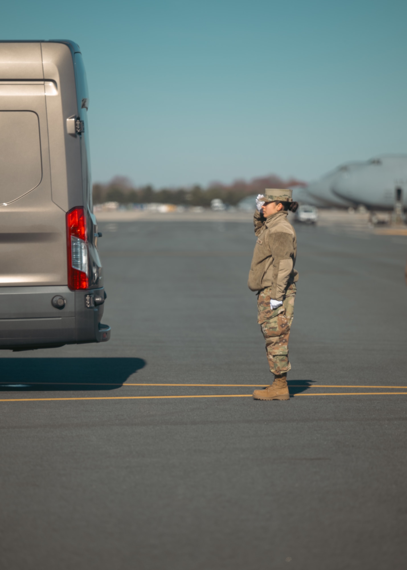 A female service member salutes a transfer vehicle during a Dignified Transfer ground training.