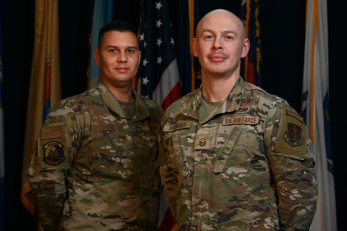 Two Airmen Recruiters stand next to each other for portrait photo.