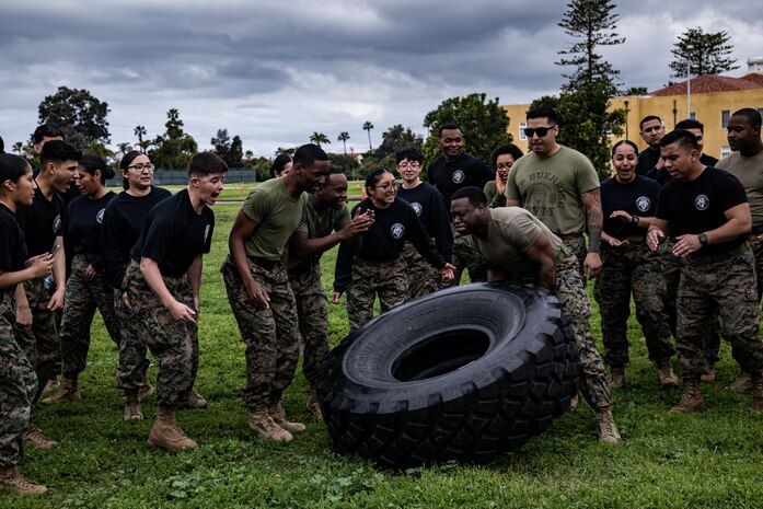 U.S. Marines with Headquarters Company, Headquarters and Service Battalion, conduct the tire flip race event as part of the Atlas Games at Marine Corps Recruit Depot San Diego, California, Feb. 29, 2024. The Atlas Games is an annual battalion field meet that incorporates leadership skills and teamwork to enhance individual readiness, unit cohesion, boost morale, and foster esprit de corps among Marines. (U.S. Marine Corps photo by Sgt. Jesse K. Carter-Powell)