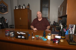 Donald MacMillan, 509th Security Forces Squadron chief of plans and programming, sits at his desk at Whiteman Air Force Base, Mo., Feb. 26, 2024. MacMillan retired from the Air Force as a Chief Master Sgt. and returned as a civilian employee to keep sharing his knowledge and experience with future generations of Airmen.