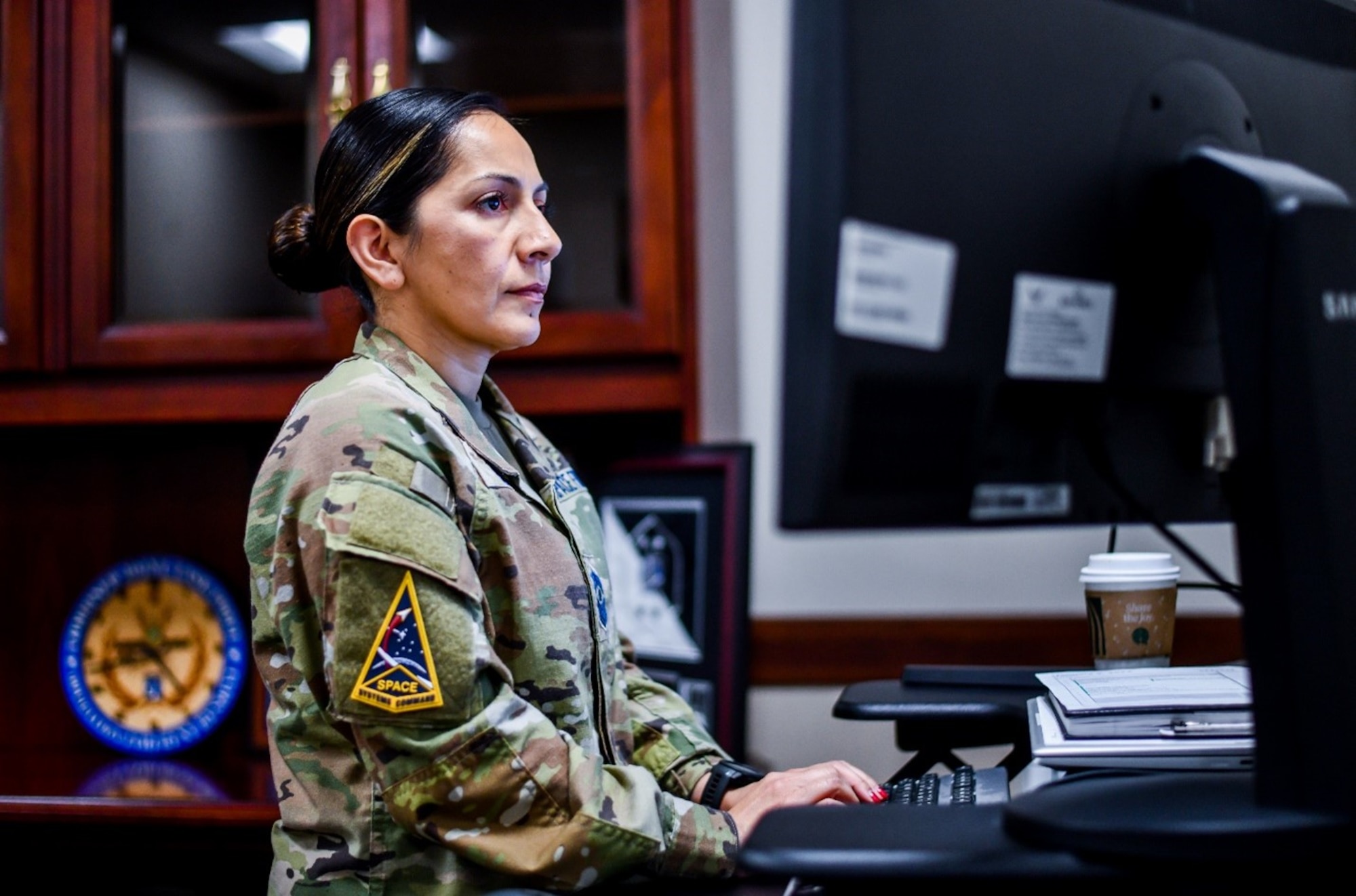 Chief Master Sgt. Jacqueline Sauvé, Space Systems Command’s new senior enlisted leader, works at her desk inside SSC headquarters on Los Angeles Air force Base in El Segundo, Calif. As the Senior Enlisted Leaser to the SSC Commander, Sauvé serves as an advisor on all matters of professional development, work force utilization, military readiness, morale, welfare and mission effectiveness for a force of more than 15,000 personnel assigned to 29 geographically separated units. (U.S. Space Force photo by Van Ha)