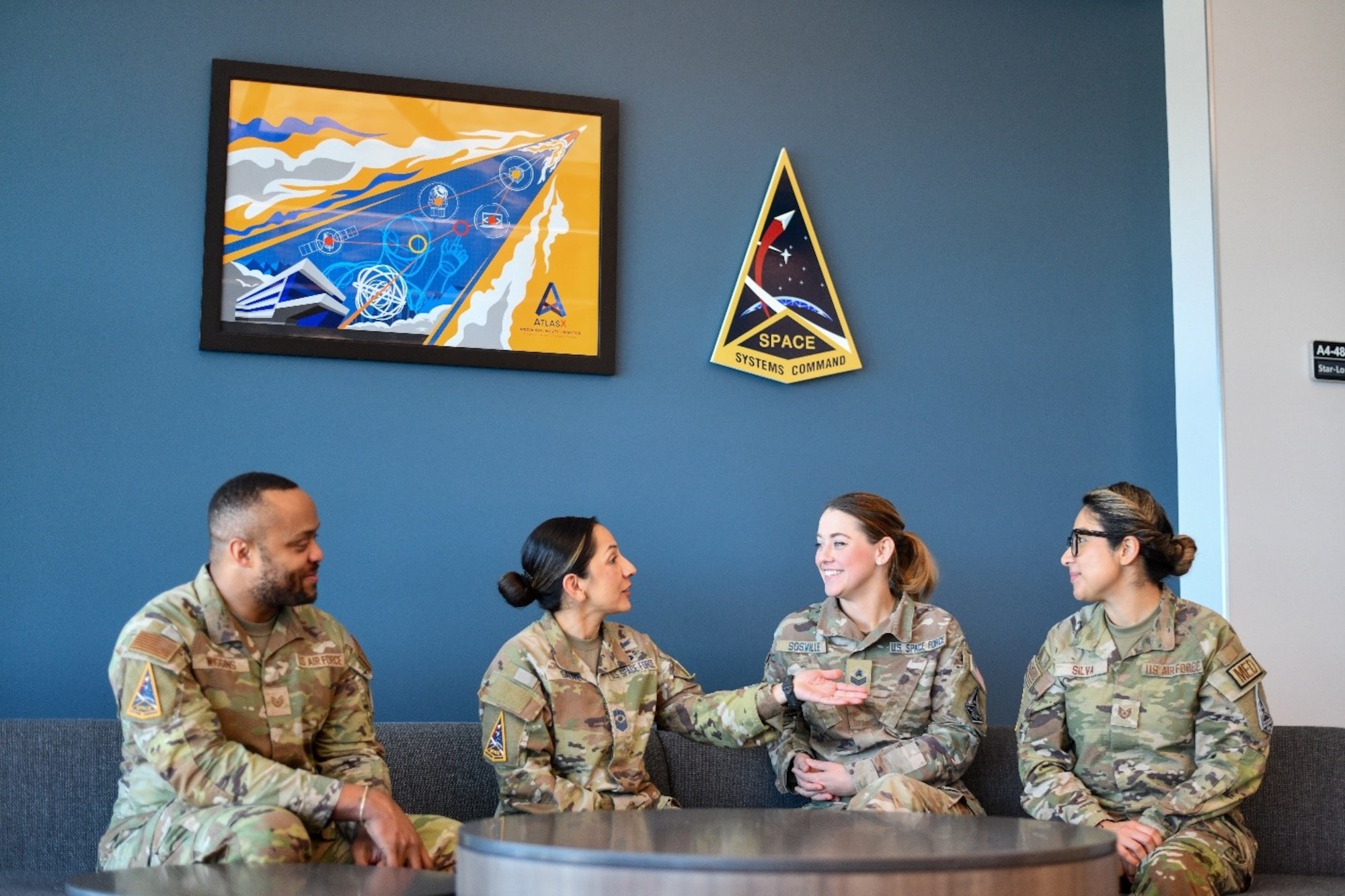 (Left to right) – U.S. Air Force Technical Sgt. Brandon Wiggins, manager, Senior Leader Management Office; U.S. Space Force Chief Master Sgt. Sauvé, Space Systems Command’s newest Senior Enlisted Leader; USSF Sgt. Michaela Sosville, product support manger, and USAF Technical Sgt. Jessika Silva, executive assistant to the SEL, have a discussion in SSC’s Guardian Lab on Los Angeles Air Force Base in El Segundo, Calif. Suavé emphasized that readiness also requires Guardians to stay the course when being bold problem solvers and to free up space that detracts from creative and critical thinking. “Readiness isn’t just the operational, technical expertise – do we have the right equipment? Do we have the right trained individuals – it’s beyond that: what are the things that can distract our members from focusing on the mission?” Sauvé said. (U.S. Space Force photo by Van Ha)