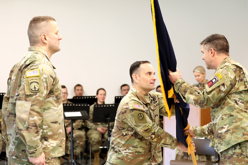 Brig. Gen. Richard Corner, outgoing commanding general of the 85th U.S. Army Reserve Support Command gives the colors to Maj. Gen. Mark Landes, acting commanding general of First Army, during a relinquishment of command ceremony March 1, 2024, in Arlington Heights, Illinois.