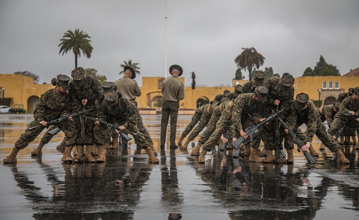 U.S. Marine Corps recruits with Mike Company, 3rd Recruit Training Battalion, create rifle stacks as a part of the final drill evaluation at Marine Corps Recruit Depot San Diego, California, Mar. 2, 2024. During the final drill evaluation, the platoons are scored based on their uniforms, bearing, and movements, as well as the senior drill instructor’s cadence, sword control, and movement commands. (U.S. Marine Corps photo by Sgt. Jesse K. Carter-Powell)