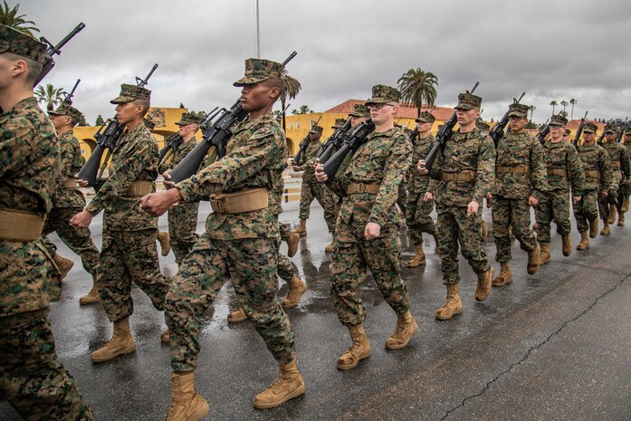 U.S. Marine Corps recruits with Mike Company, 3rd Recruit Training Battalion, march in formation as part of the final drill evaluation at Marine Corps Recruit Depot San Diego, California, Mar. 2, 2024. During the final drill evaluation, the platoons are scored based on their uniforms, bearing, and movements, as well as the senior drill instructor’s cadence, sword control, and movement commands. (U.S. Marine Corps photo by Sgt. Jesse K. Carter-Powell)