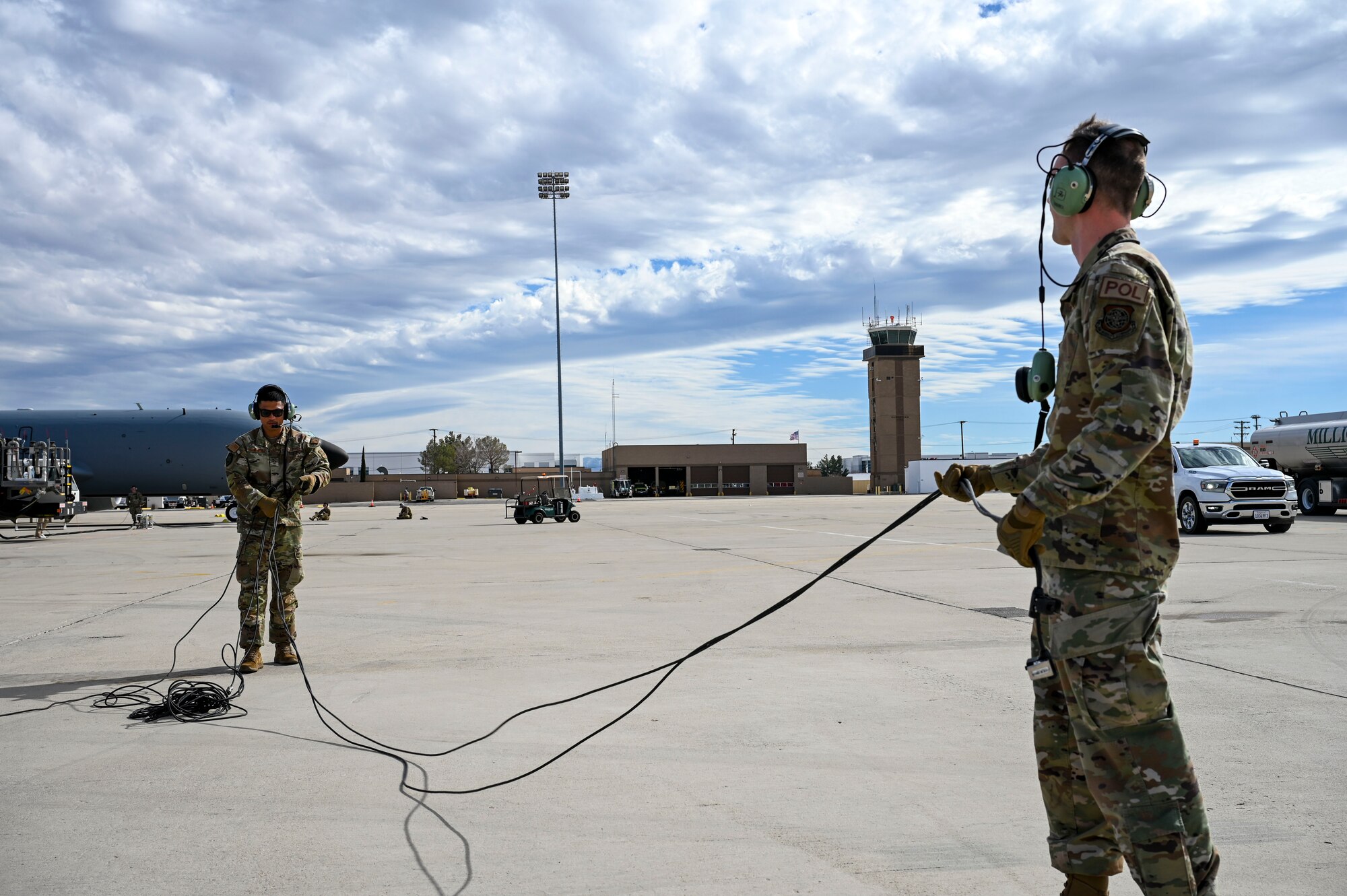 Airmen untangle a cord.
