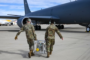 An Airman locks a jet ladder into place