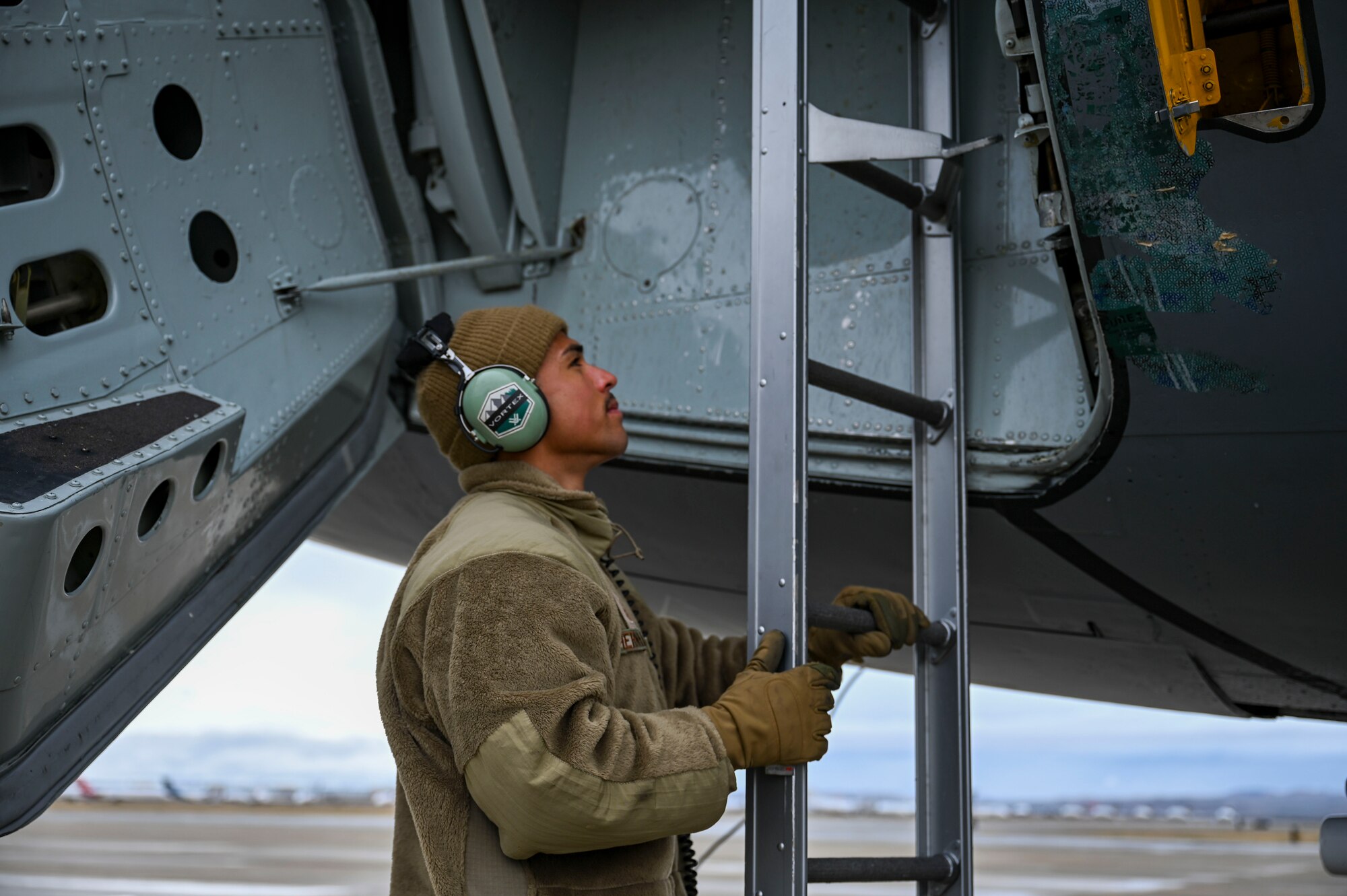 An Airman locks a jet ladder into place