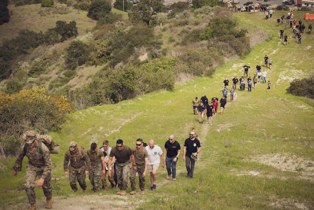 Veterans of 2nd Battalion, 1st Marine Regiment, 1st Marine Division, along with their friends and families, hike up to the Camp Horno memorial crosses as part of a reunion hike for the 20th anniversary of Operation Vigilant Resolve, also known as the first Battle of Fallujah, at Marine Corps Base Camp Pendleton, California, Feb. 29, 2024. The hike brought together approximately 150 veteran and active-duty Marines and Sailors who served with 2nd Bn., 1st Marines, during Operation Vigilant Resolve in 2004. (U.S. Marine Corps photo by Sgt. Ezekieljay Correa)