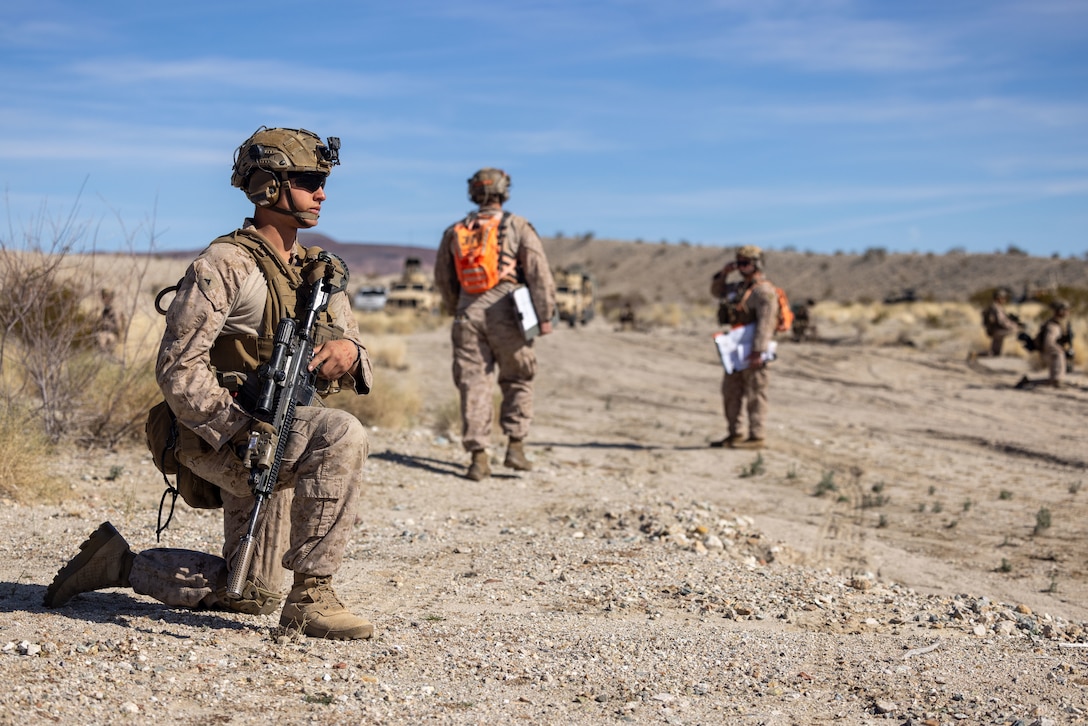 U.S. Marine Corps Lance Cpl. Ryker Sachs, a West Jordan, Utah native, infantry Marine with 2nd Battalion, 4th Marine Regiment, 1st Marine Division, left, provides security during a ground assault as part of a Marine Air-Ground Task Force Distributed Maneuver Exercise as part of Service Level Training Exercise 2-24 around Gays Pass training area, at Marine Corps Air-Ground Combat Center, Twentynine Palms, California, Feb. 14, 2024. MDMX prepares Marines for future conflicts by conducting offensive and defensive live-fire and maneuver training scenarios within an austere training environment. (U.S. Marine Corps photo by Lance Cpl. Anna Higman)