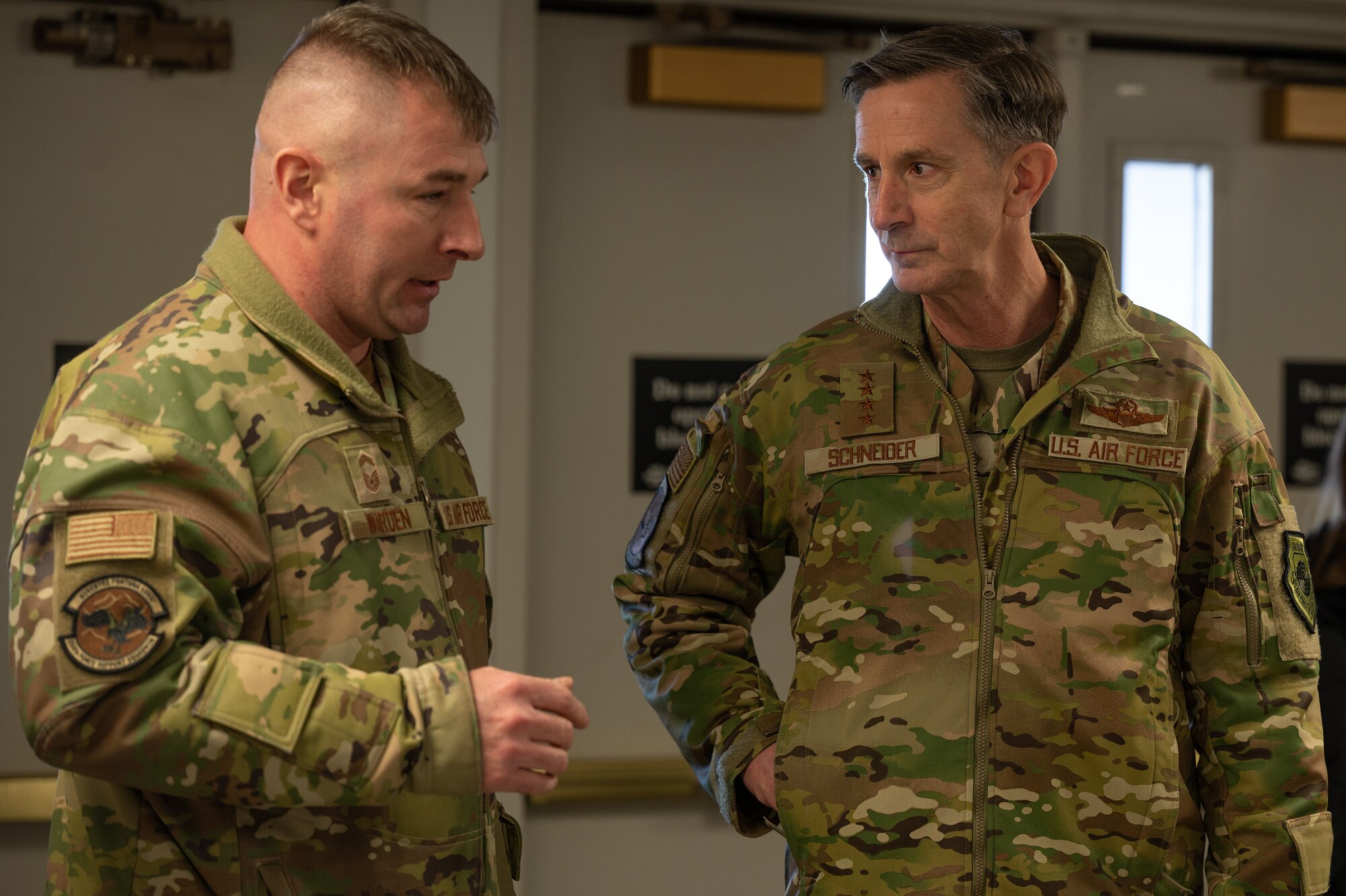 U.S. Air Force Gen. Kevin Schneider, Pacific Air Forces commander, receives a briefing from SMSgt. Matthew Warden, 354th Force Support Squadron senior enlisted leader, about the capability to transform Baker Field House into a temporary hospital at Eielson Air Force Base, Alaska, Feb. 29, 2024. During the general’s visit he also toured the medical group to better understand access to care challenges, mental health, and physical therapy modifications in Alaska. (U.S. Air Force photo by Airman Spencer Hanson)