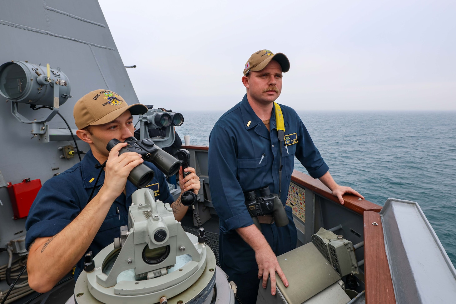 TAIWAN STRAIT (March 5, 2024) Ensign Zane Stone-Dudney, left, and Ensign Rich Hansen, stand watch aboard the Arleigh Burke-class guided-missile destroyer USS John Finn (DDG 113) during routine operations  while transiting through the Taiwan Strait, March 5. John Finn is forward-deployed and assigned to Destroyer Squadron (DESRON) 15, the Navy’s largest DESRON and the U.S. 7th Fleet’s principal surface force. (U.S. Navy photo by Mass Communication Specialist 2nd Class Justin Stack)