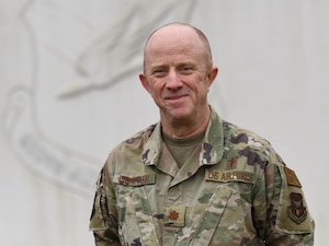 Chaplain Jeffrey Lichlyter, 910th Airlift Wing Chaplain poses for a photo at the entrance to Youngstown Air Reserve Station, Ohio, on March 2, 2024.