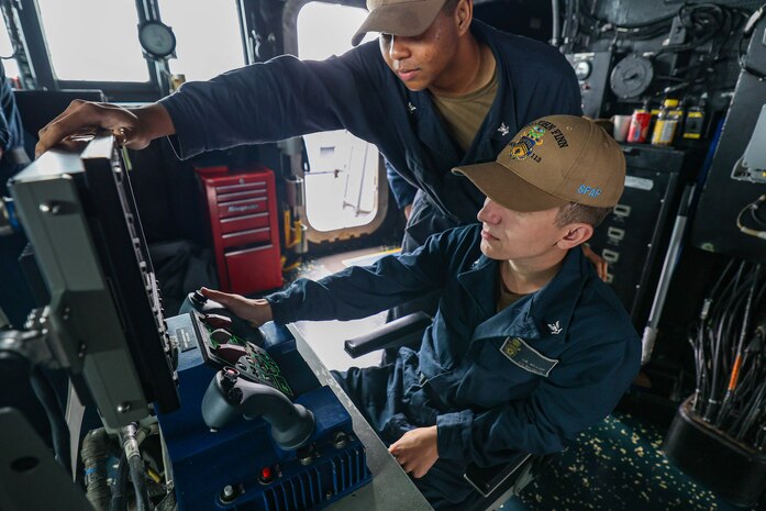 TAIWAN STRAIT (March 5, 2024) Gunners Mate 3rd Class Joseph Braam, right, from Bemidji, Minnesota, and Gunners Mate 2nd Class T.J. Nguyen, from Houston, Texas, stand watch aboard the Arleigh Burke-class guided-missile destroyer USS John Finn (DDG 113) during a transit through the Taiwan Strait, March 5. John Finn is forward-deployed and assigned to Destroyer Squadron (DESRON) 15, the Navy’s largest DESRON and the U.S. 7th Fleet’s principal surface force. (U.S. Navy photo by Mass Communication Specialist 2nd Class Justin Stack)