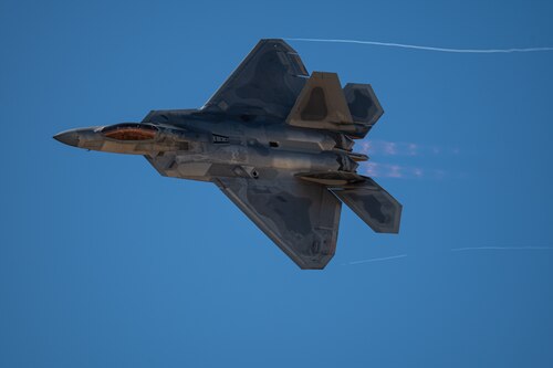 An F-22 Raptor aircraft flies during the Heritage Flight Training Course at Davis-Monthan Air Force Base, Ariz., March 1, 2024. The F-22 Demonstration Team flew at air shows around the globe, performing air demonstrations that include the power loop, split, tail slide, as well as a high speed pass and dedication pass. (U.S. Air Force photo by Airman 1st Class Jasmyne Bridgers-Matos)