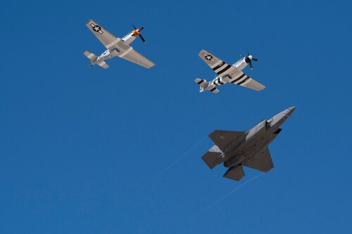 An F-35A Lightning II aircraft flies alongside two P-51 Mustang aircrafts during the Heritage Flight Training Course at Davis-Monthan Air Force Base, Ariz., March 1, 2024. During HFTC, aircrew practice ground and flight training to enable civilian pilots of historic military aircraft and U.S. Air Force pilots of current fighter aircraft to fly safely in formations together. (U.S. Air Force photo by Airman 1st Class William Finn)