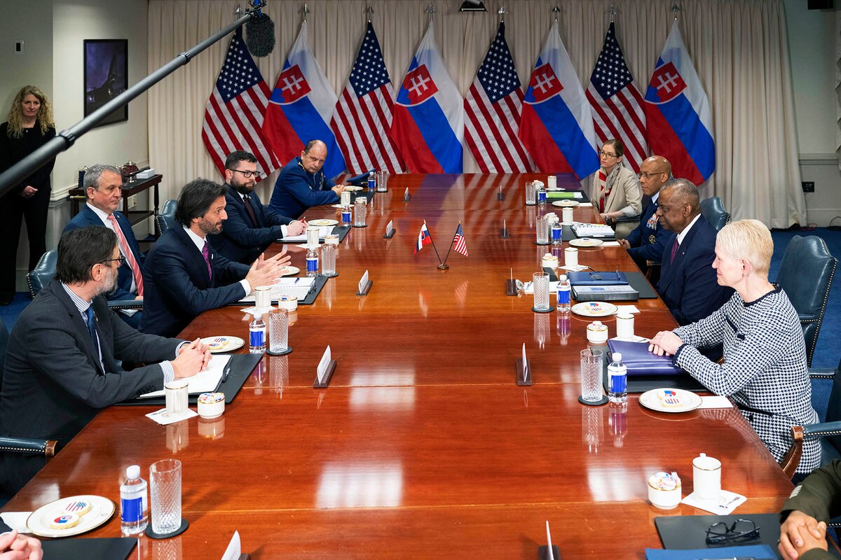 A group of people meet around a large table.