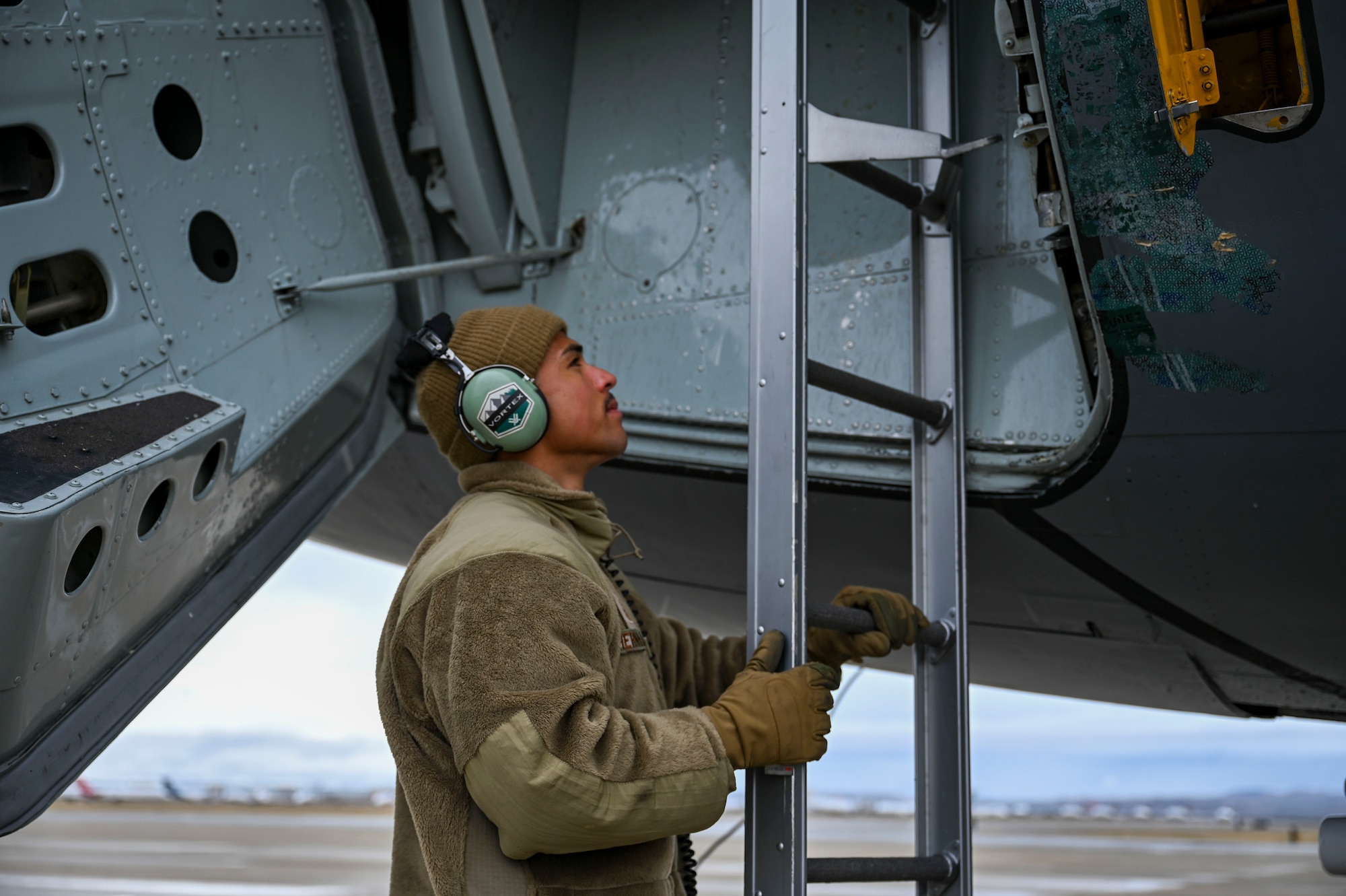 An Airman locks a jet ladder into place