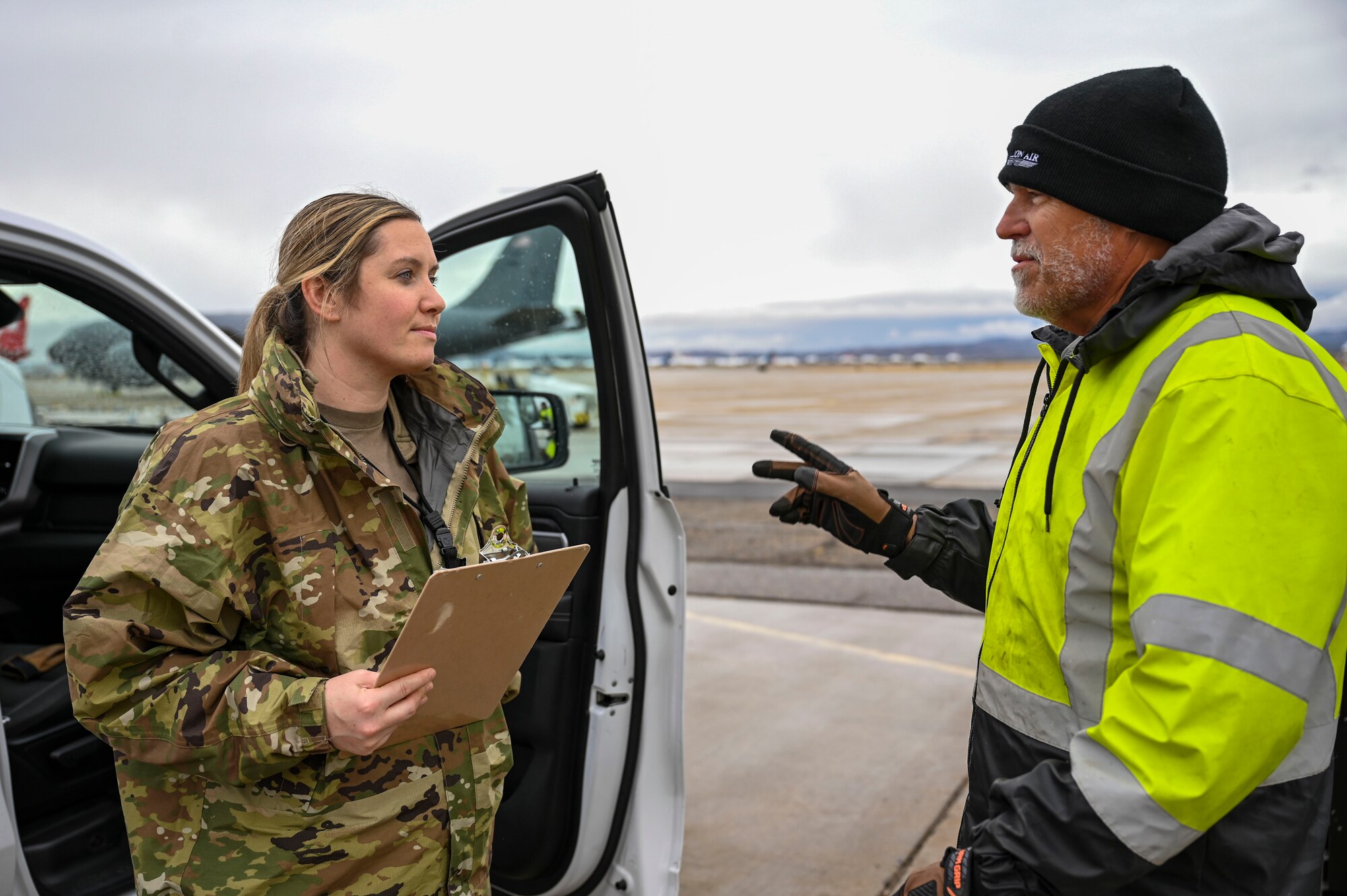 An Airman speaks to an airport attendant.