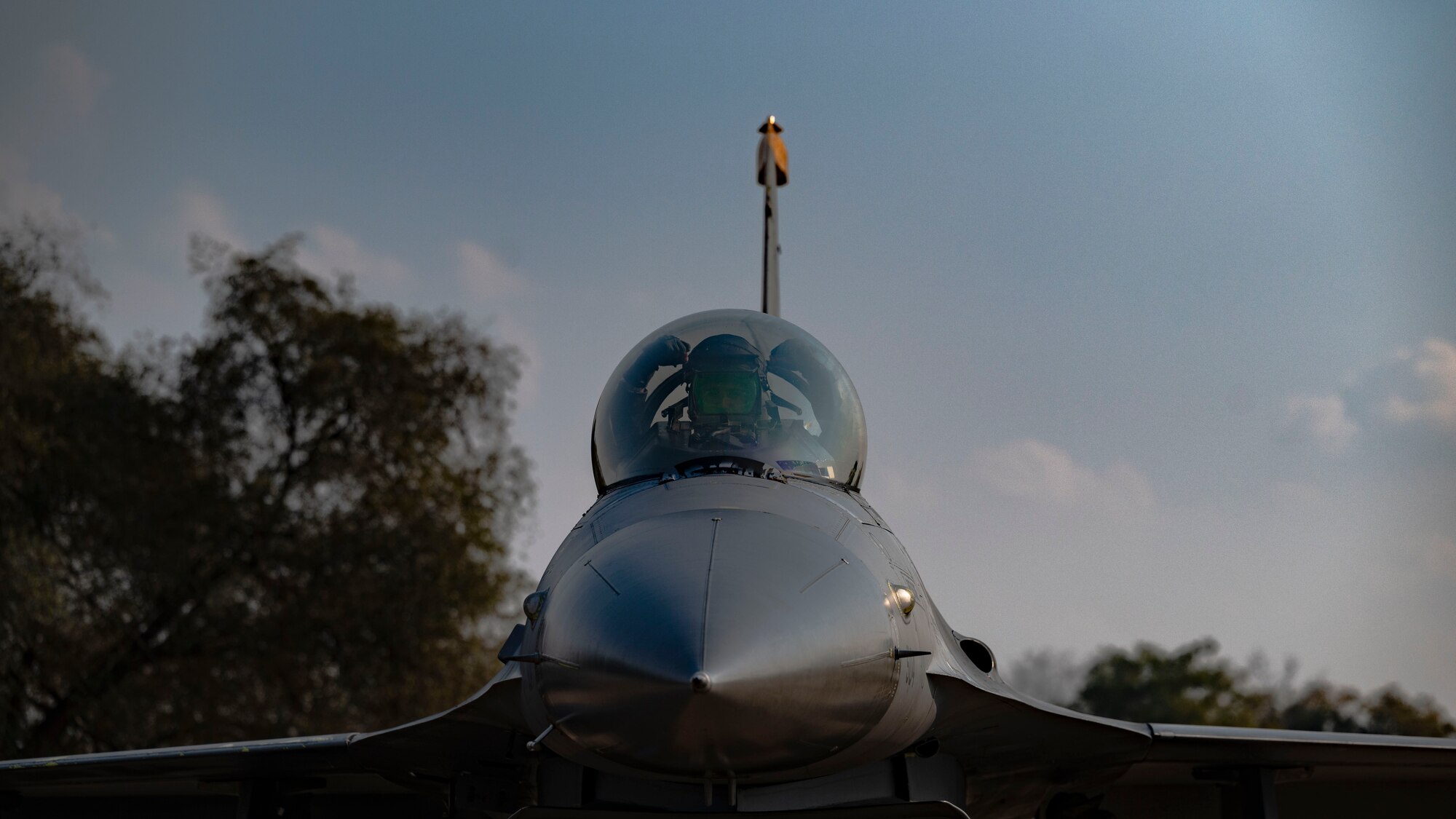 F-16 Fighting Falcon pilot, performs a gesture of squadron pride upon arrival after participating in a maritime strike exercise scenario