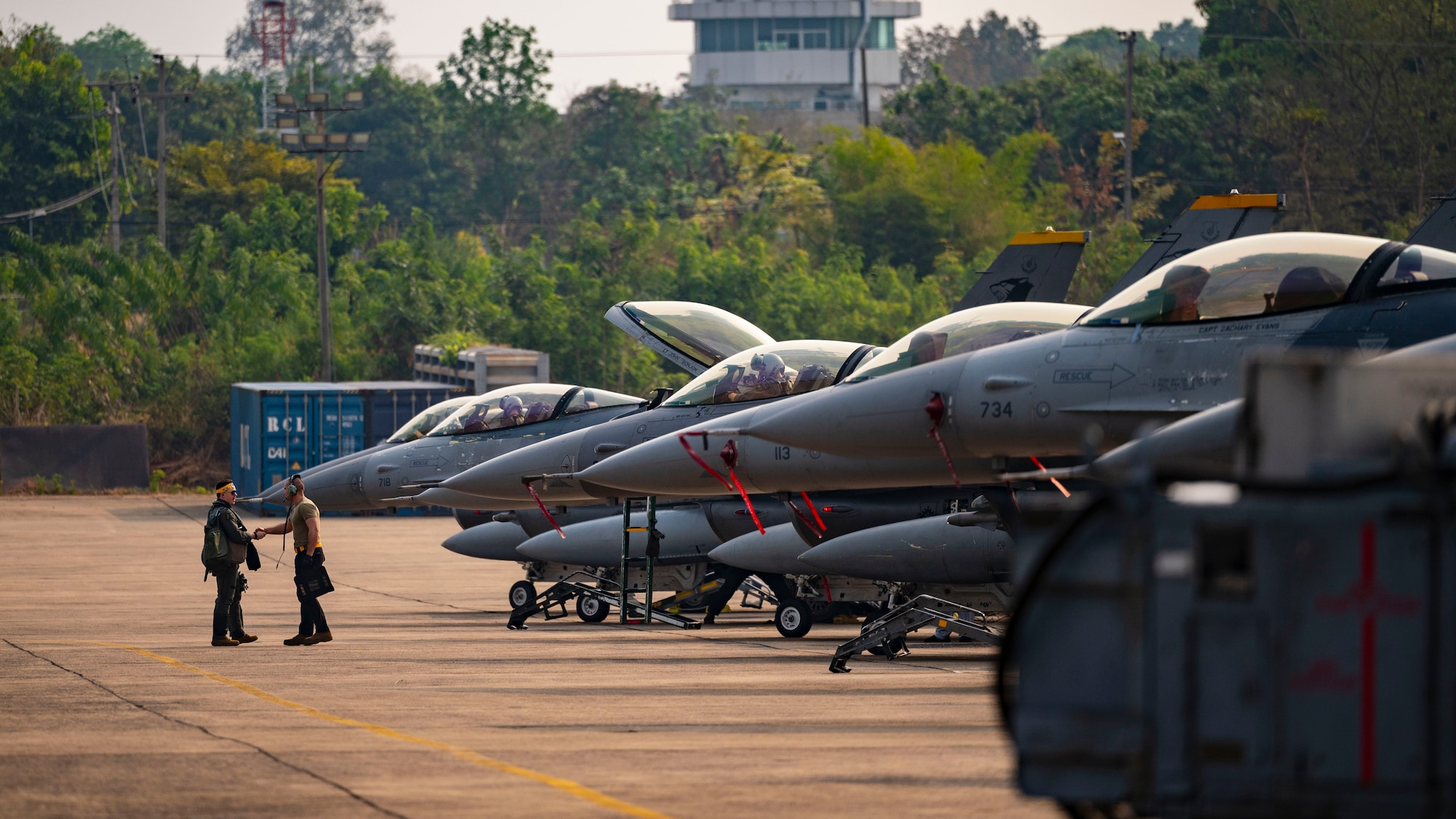 A dedicated crew chief, greets an F-16 Fighting Falcon pilot at Korat Royal Thai Air Force Base