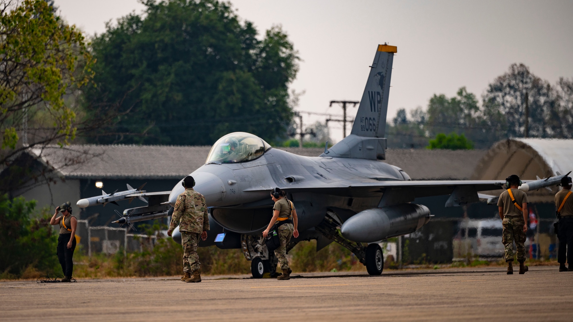 Airmen provide maintenance support for the departure of an F-16 Fighting Falcon