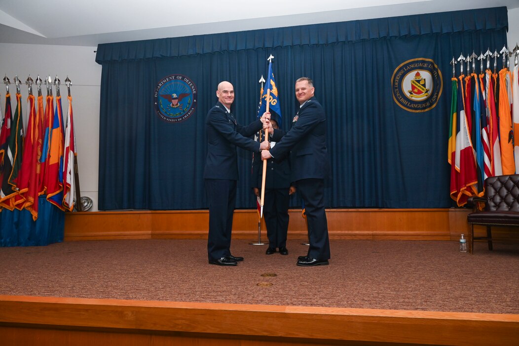 Col. William Gutermuth, 433rd Airlift Wing commander, presents the guidon to Col. James Bershinsky, 433rd Medical Group commander, during the 433rd MDG assumption of command ceremony at Joint Base San Antonio-Lackland, Texas, March 3, 2024.