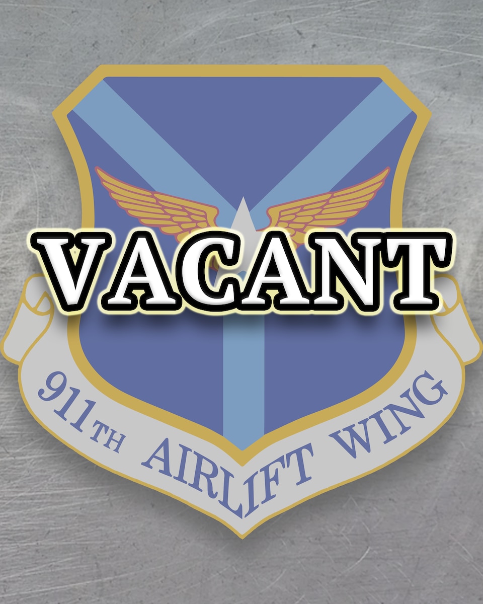 Graphic consists of sheet metal as background with the 911th Airlift Wing shield superimposed atop, with the text VACANT.