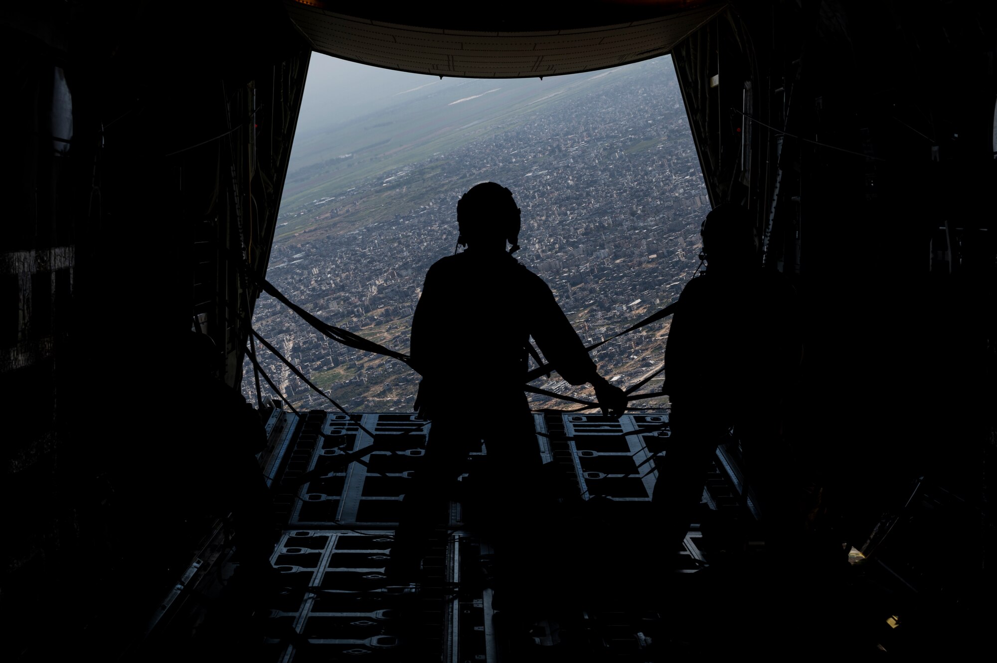 A loadmaster stands on the ramp of a HC-130J Combat King II after airdropping humanitarian aid over Gaza.