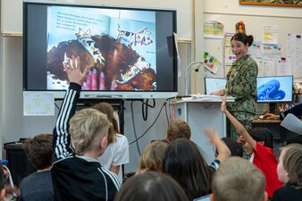 YN2 Celestina Bittel reads to Rota Elementary School students at Naval Station Rota, Spain.