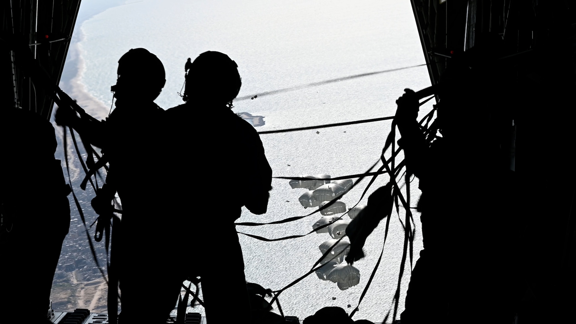 Loadmasters stands on the ramp of a HC-130J Combat King II after airdropping humanitarian aid over Gaza.