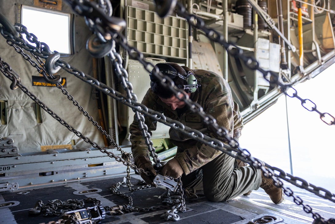 Tech. Sgt. Eric Junquera, a loadmaster with the New York Air National Guard, tightens the tie-down straps securing a High Mobility Artillery Rocket System (HIMARS) to a C-130 Hercules aircraft in support of Arctic Edge 24 at Eielson Air Force Base, Alaska, Feb. 24, 2024. AE24 is an annual defense exercise for the U.S. Northern Command emphasizing Joint Force operations in an extreme cold weather and high latitude environment and is designed to demonstrate Globally Integrated Layered Defense in the Arctic. (U.S. Air National Guard photo by Technical Sergeant Madison Scaringe)