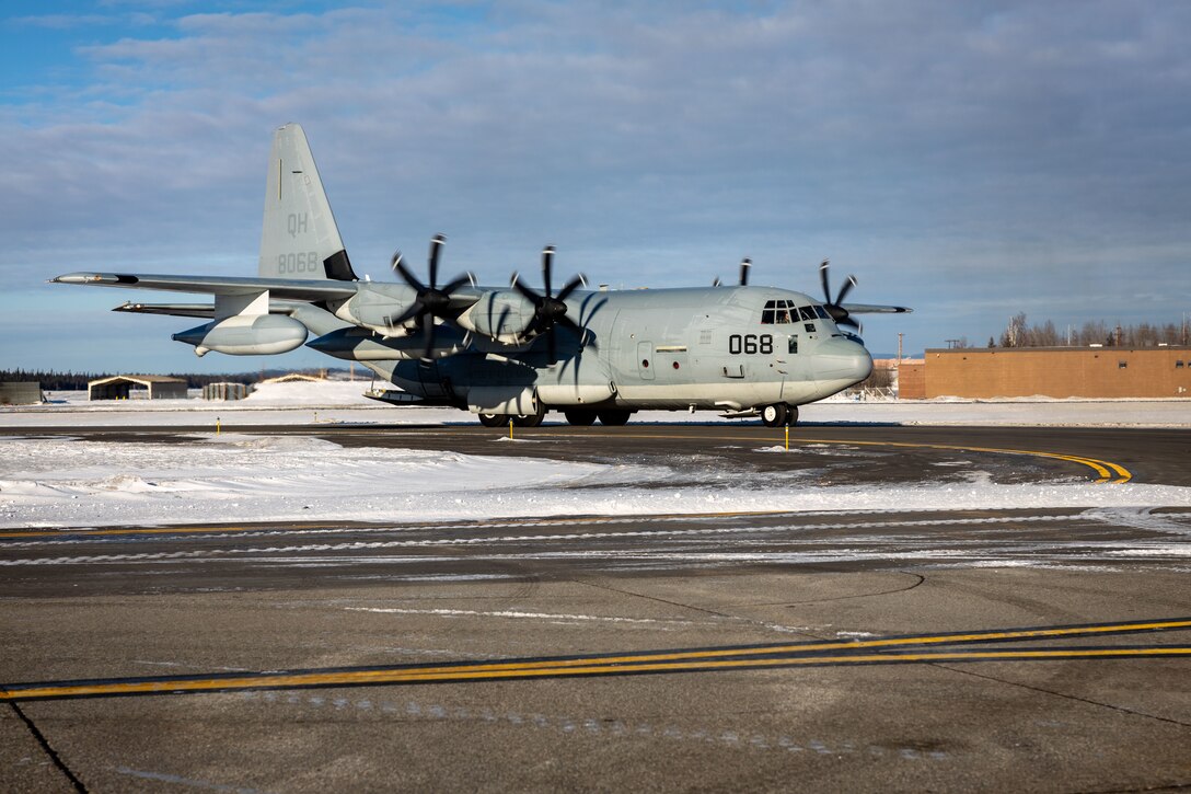 A U.S. Marine Corps C-130J Hercules assigned to Marine Aerial Refueler Transport Squadron (VMGR) 234, Marine Aircraft Group 41, 4th Marine Aircraft Wing, Marine Forces Reserve, lands before a High Mobility Artillery Rocket System (HIMARS) Rapid Infiltration, also known as a HIRAIN, with Fox Battery, 2nd Battalion, 14th Marine Regiment, 4th Marine Division, Marine Forces Reserve during exercise Arctic Edge 2024, at Eielson Air Force Base, Alaska, Feb. 24, 2024. The HIRAIN training demonstrated Marine Forces Reserve’s ability to rapidly deploy the HIMARS to meet and deter any threats in any environment, including harsh arctic environments. Arctic Edge 2024 (AE24) is a U.S. Northern Command-led homeland defense exercise demonstrating the U.S. military’s capabilities in extreme cold weather, joint force readiness, and U.S. military commitment to mutual strategic security interests in the arctic region. (U.S. Marine Corps photo by Lance Cpl. Madisyn Paschal)