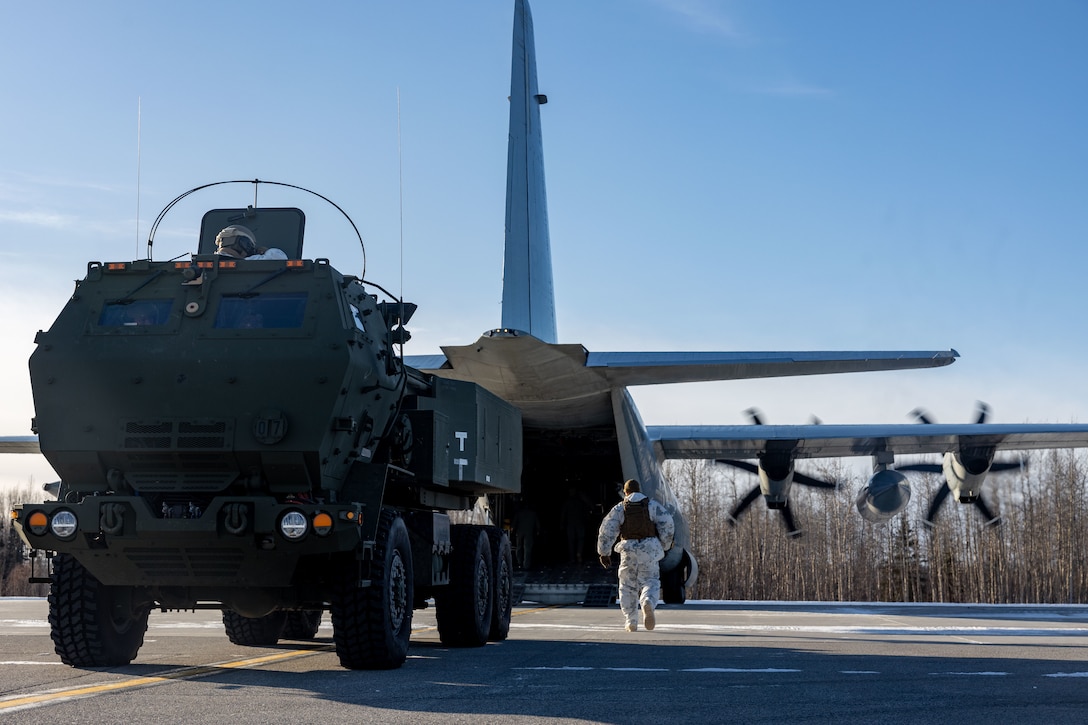 U.S. Marines with Fox Battery, 2nd Battalion, 14th Marine Regiment, 4th Marine Division, Marine Forces Reserve and Marine Aerial Refueler Transport Squadron (VMGR) 234, Marine Aircraft Group 41, 4th Marine Aircraft Wing, Marine Forces Reserve begin onloading a M142 High Mobility Artillery Rocket System (HIMARS) onto a C-130J Hercules during a HIMARS Rapid Infiltration, also known as a HIRAIN, during exercise Arctic Edge 2024 at Eielson Air Force, Alaska, Feb. 24, 2024. The HIRAIN training demonstrated Marine Forces Reserve’s ability to rapidly deploy the HIMARS to meet and deter any threats in any environment, including harsh arctic environments. Arctic Edge 2024 (AE24) is a U.S. Northern Command-led homeland defense exercise demonstrating the U.S. military’s capabilities in extreme cold weather, joint force readiness, and U.S. military commitment to mutual strategic security interests in the arctic region. (U.S. Marine Corps photo by Lance Cpl. Madisyn Paschal)