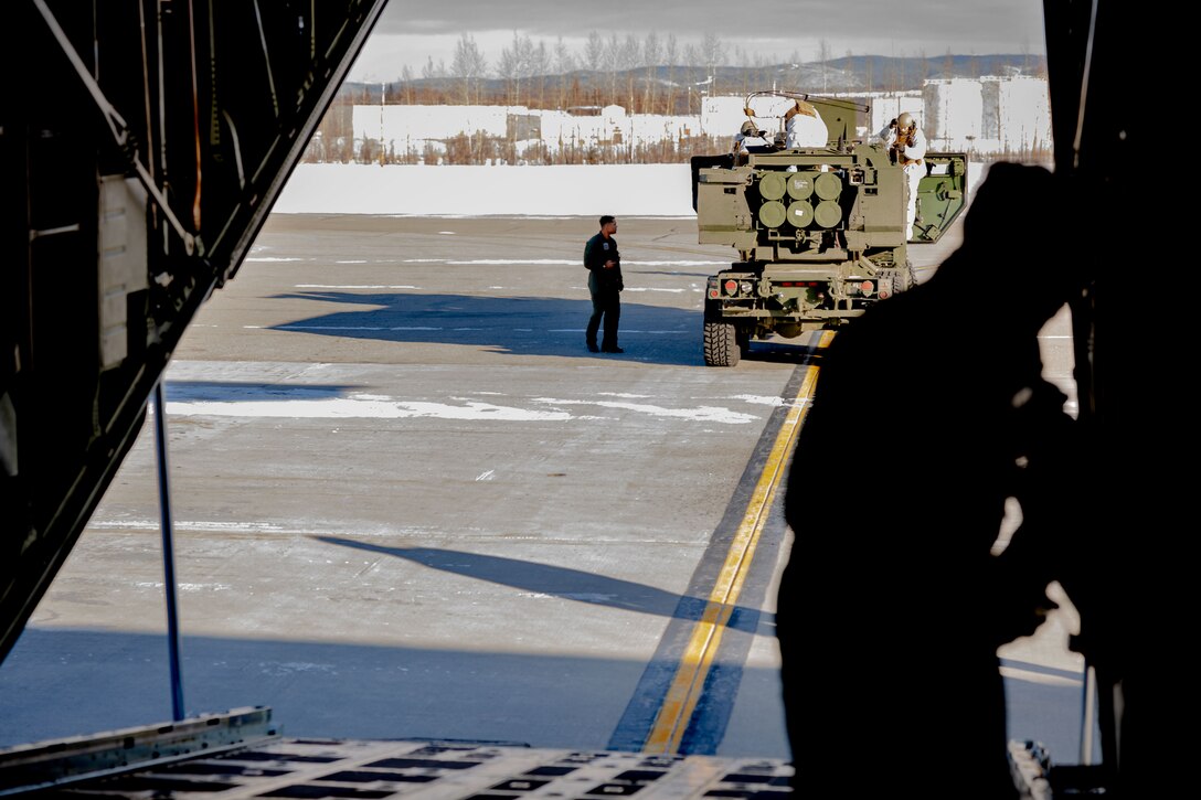 U.S. Marines with Fox Battery, 2nd Battalion, 14th Marine Regiment, 4th Marine Division, Marine Forces Reserve and Marine Aerial Refueler Transport Squadron (VMGR) 234, Marine Aircraft Group 41, 4th Marine Aircraft Wing, Marine Forces Reserve on load a M142 High Mobility Artillery Rocket System (HIMARS) onto a C-130J Hercules during a HIMARS Rapid Infiltration, also known as a HIRAIN, during exercise Arctic Edge 2024 at Eielson Air Force, Alaska, Feb. 24, 2024. The HIRAIN training demonstrated Marine Forces Reserve’s ability to rapidly deploy the HIMARS to meet and deter any threats in any environment, including harsh arctic environments. Arctic Edge 2024 (AE24) is a U.S. Northern Command-led homeland defense exercise demonstrating the U.S. military’s capabilities in extreme cold weather, joint force readiness, and U.S. military commitment to mutual strategic security interests in the arctic region. (U.S. Marine Corps photo by Lance Cpl. Madisyn Paschal)