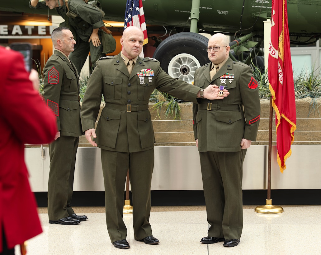 U.S. Marine Corps Lt. Gen. David G. Bellon, commander of U.S. Marine Corps Forces Reserve and U.S. Marine Corps Forces South, presents retired Lance Cpl. Jeremy R. Williams, a Texas native, with the Purple Heart at the National Museum of the Marine Corps, Triangle, Virginia, March 2, 2024. Williams suffered a traumatic brain injury directly related to an improvised explosive device incident in Ramadi, Iraq, on May 15, 2006. (U.S. Marine Corps photo by Lance Cpl. David Brandes)
