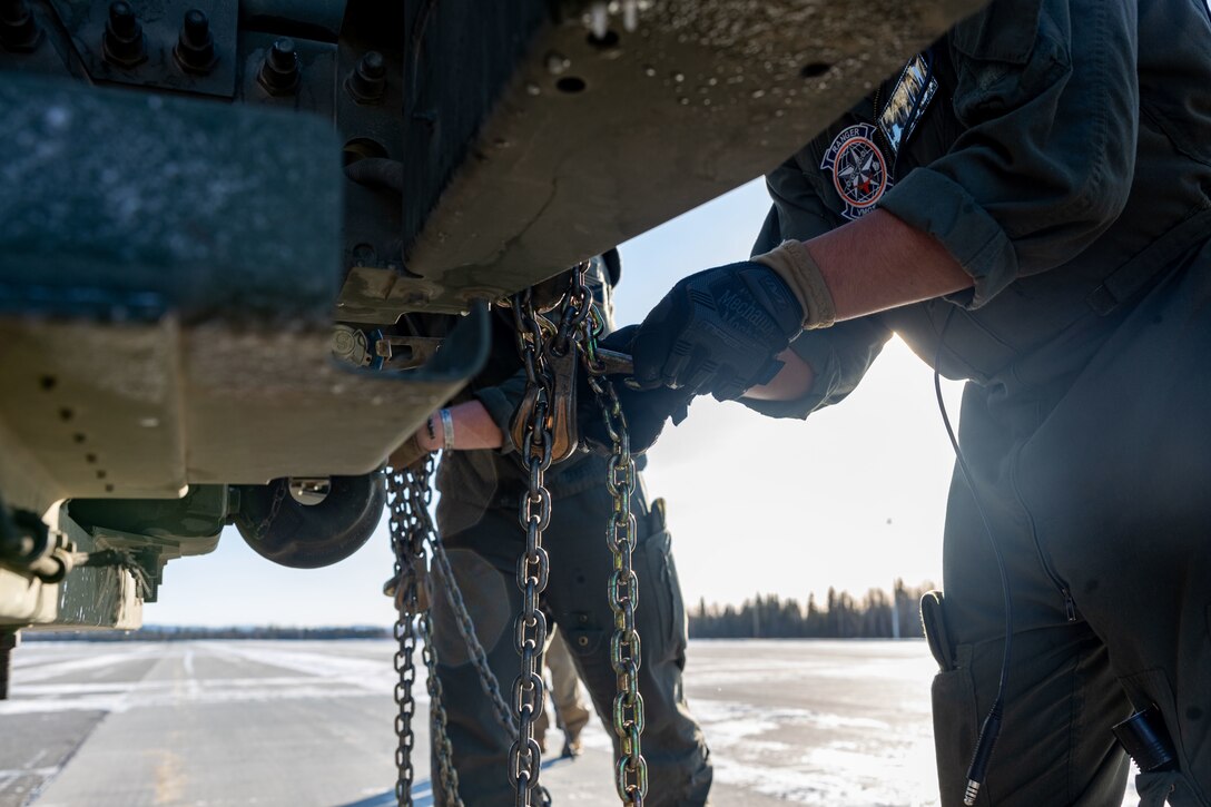 U.S. Marine Corps Lance Cpl. Anthony Gawne, Fixed-Wing Aircraft Loadmaster with Marine Aerial Refueler Transport Squadron (VMGR) 234, Marine Aircraft Group 41, 4th Marine Aircraft Wing, Marine Forces Reserve, prepares to onload a M142 High Mobility Artillery Rocket System (HIMARS) during a HIMARS Rapid Infiltration, also known as a HIRAIN, with Fox Battery, 2nd Battalion, 14th Marine Regiment, 4th Marine Division, Marine Forces Reserve during exercise Arctic Edge 2024 at Eielson Air Force, Alaska, Feb. 24, 2024. The HIRAIN training demonstrated Marine Forces Reserve’s ability to rapidly deploy the HIMARS to meet and deter any threats in any environment, including harsh arctic environments. Arctic Edge 2024 (AE24) is a U.S. Northern Command-led homeland defense exercise demonstrating the U.S. military’s capabilities in extreme cold weather, joint force readiness, and U.S. military commitment to mutual strategic security interests in the arctic region. (U.S. Marine Corps photo by Lance Cpl. Madisyn Paschal)